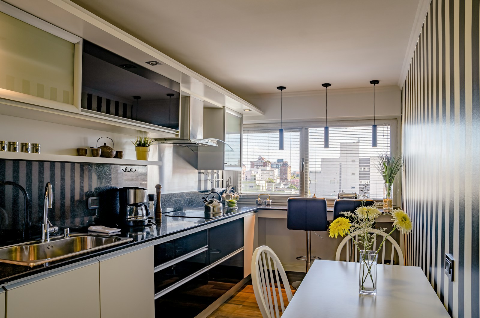 a kitchen with a table and chairs next to a window