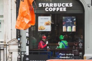 two men with Super Mario and Luigi costumes sitting inside Starbucks coffee cafe
